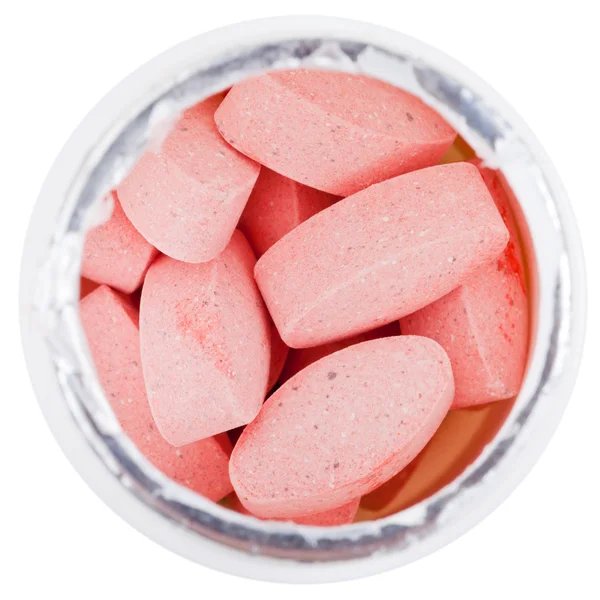 Pílulas rosa em recipiente branco — Fotografia de Stock