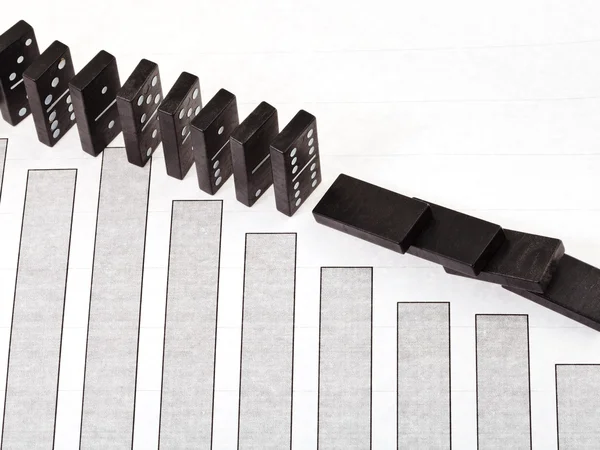 Fallen domino and falling sales diagram — Stock Photo, Image