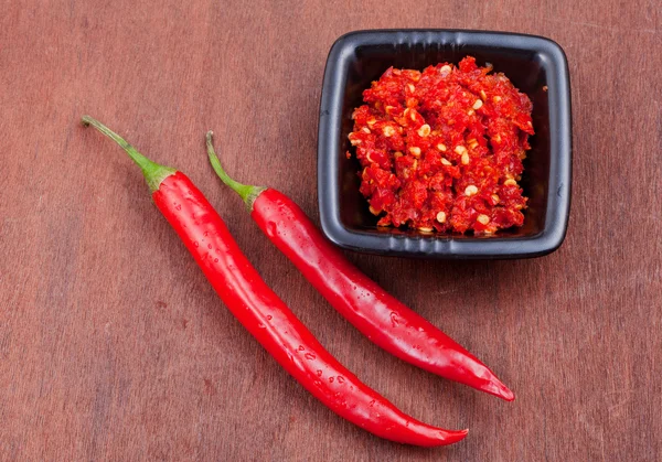 Pods of red hot pepper and spicy sauсe — Stock Photo, Image
