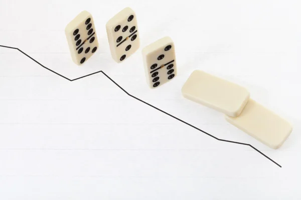 Falled domino and graph of decline results — Stock Photo, Image