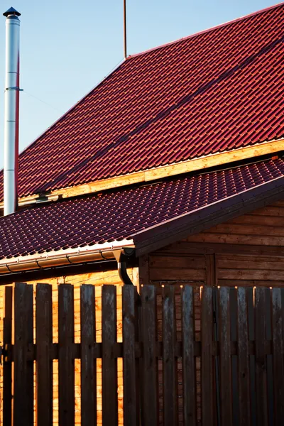 Fence, chimney,red tile of new wooden house — Stock Photo, Image