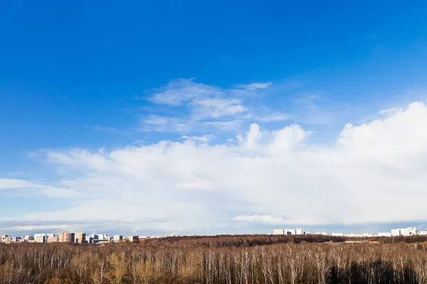 Wide white clouds under city — Stock Photo, Image