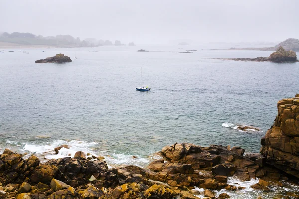 Barco cerca de la costa rocosa de Bretaña — Foto de Stock