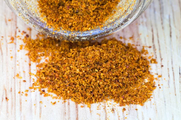 Cayenne pepper spilled from glass jar — Stock Photo, Image