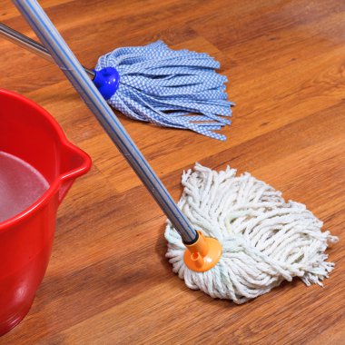mopping of wood floors by two mops clipart