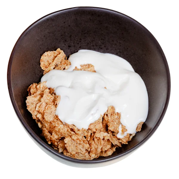 Yoghurt into bowl of cereal — Stock Photo, Image