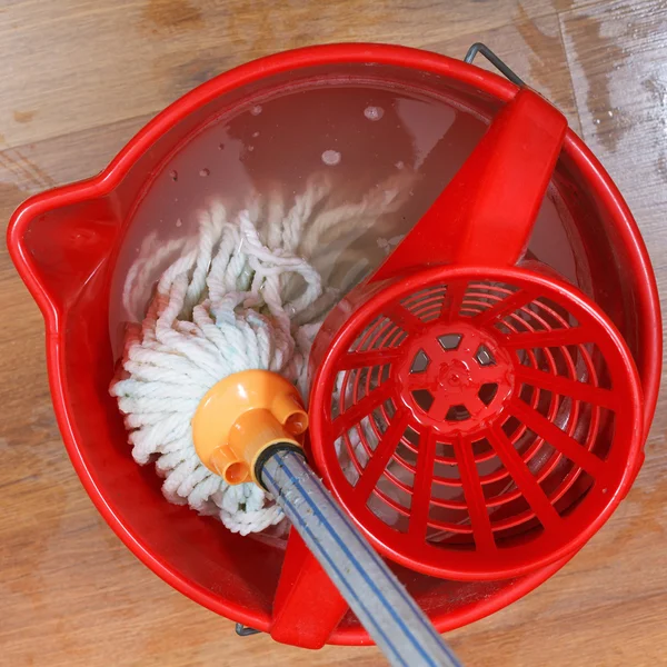 Washing mop in red bucket — Stock Photo, Image