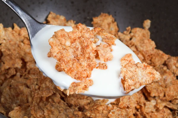 Spoon with yogurt and cornflakes — Stock Photo, Image
