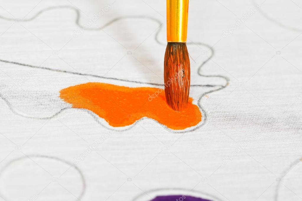 Painting orange ornament on silk canvas