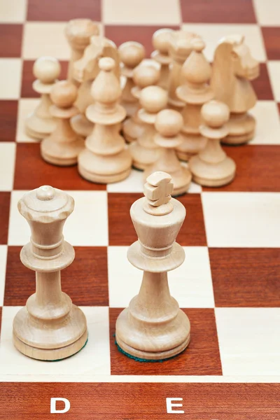 Chess pieces against the king and queen — Stock Photo, Image