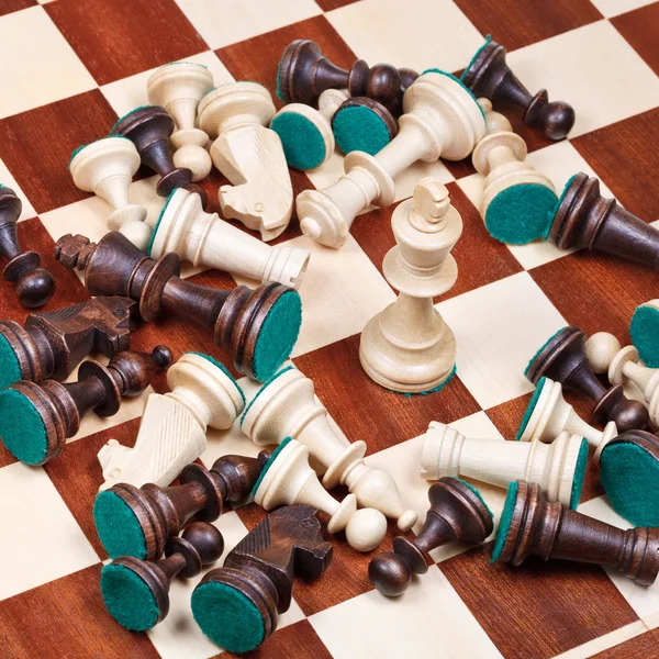 White king and scattered chess pieces — Stock Photo, Image