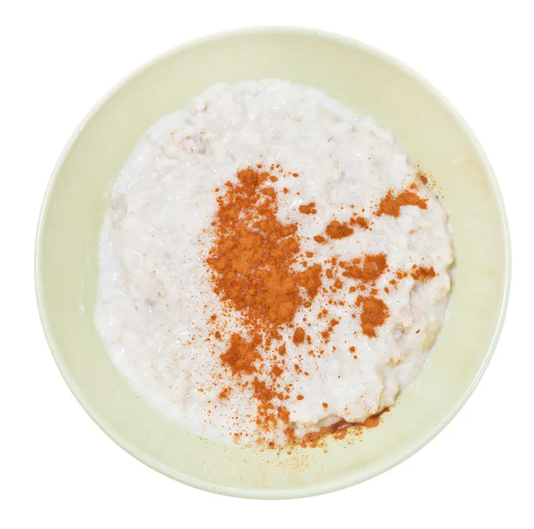Oat porridge with cinnamon in yellow bowl — Stock Photo, Image