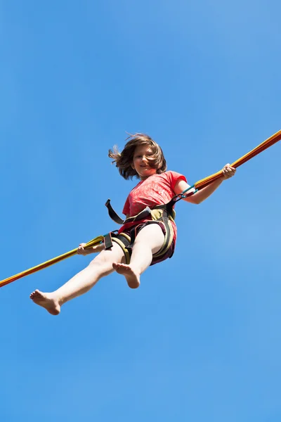 Girl jumps on bungee cord — Stock Photo, Image