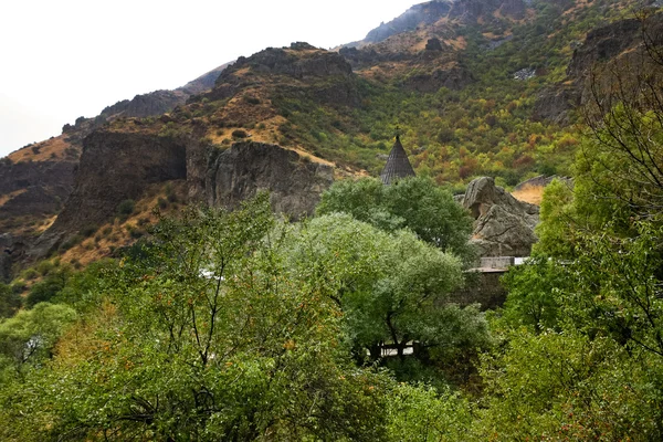 Geghard monastery and cliffs in Armenia — Stock Photo, Image