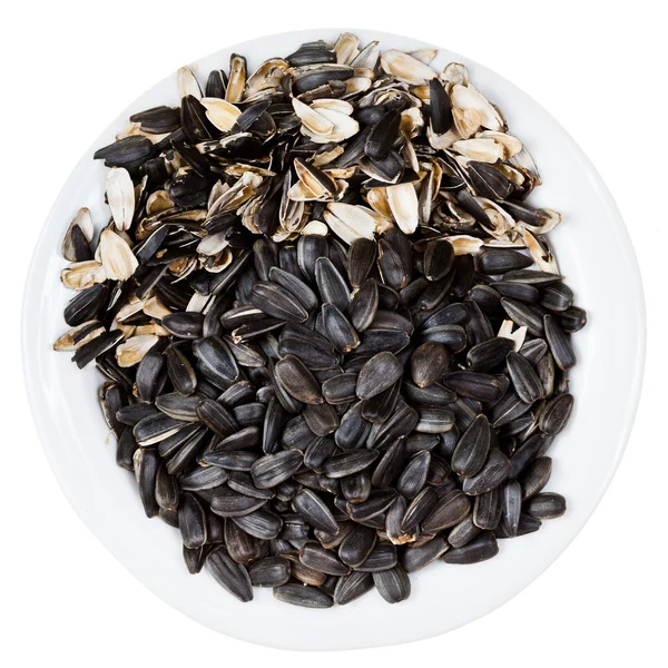 Top view of sunflower seeds and husks on plate — Stock Photo, Image