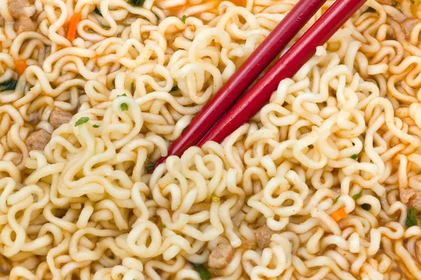 Instant noedels eten door rode eetstokjes — Stockfoto