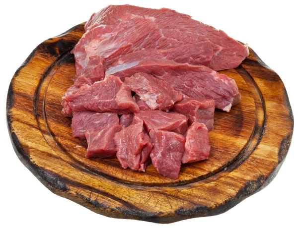 Sliced raw meat on cutting wooden board — Stock Photo, Image
