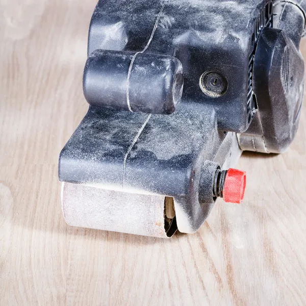 Belt sander at finished ashwood surface — Stock Image Belt sander at finished ashwood surface Royalty Free Stock Photos