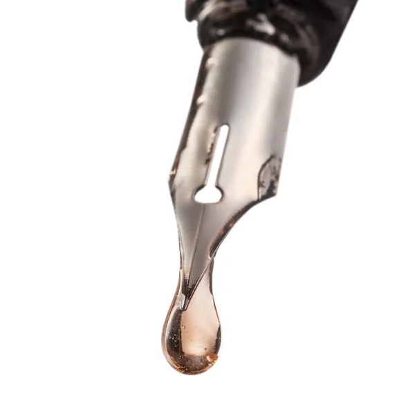 Drop of transparent liquid on tip of pen — Stock Photo, Image