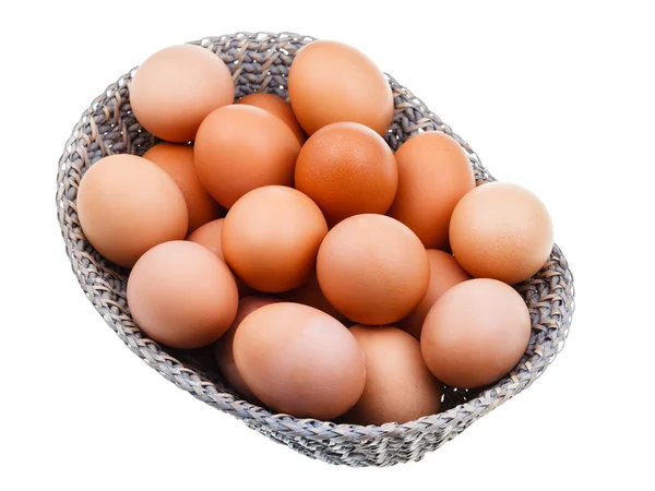 Fresh chicken eggs in wicker basket — Stock Photo, Image