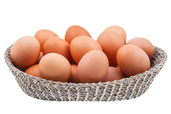 Twenty fresh chicken eggs in wicker basket — Stock Photo, Image