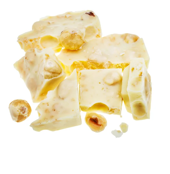 Top view of broken white chocolate with hazelnuts — Stock Photo, Image