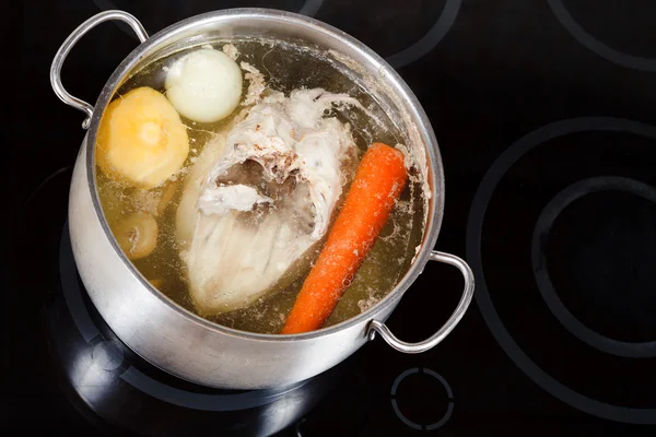 Boiling of chicken soup with seasoning vegetables — Stock Photo, Image