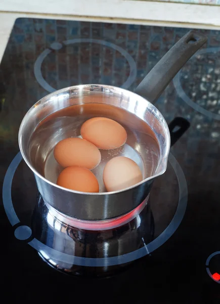 Chicken eggs are cooked in metal pot — Stock Photo, Image