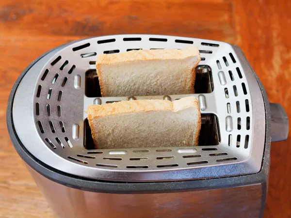 Two fresh slices of bread in metal toaster — Stock Photo, Image