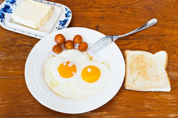 Breakfast with two fried eggs in white plate — Stock Photo, Image