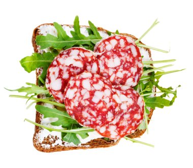 Sandwich from bread, cheese, salami and arugula clipart