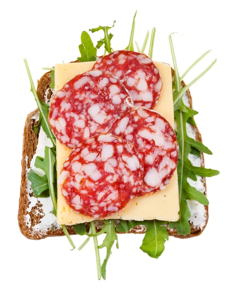 Sandwich from bread, salami, cheese, green salad — Stock Photo, Image