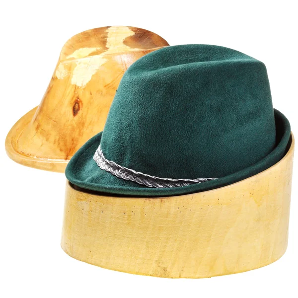 Green felt hat on linden wooden block — Stock Photo, Image