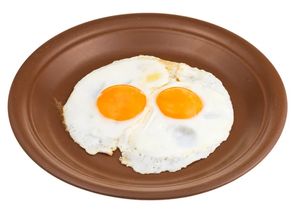 Fried eggs on ceramic brown plate — Stock Photo, Image