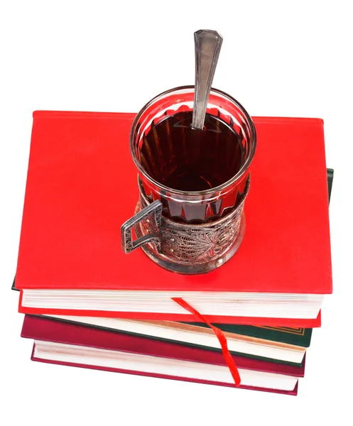 Glass of tea on stack of books — Stock Photo, Image