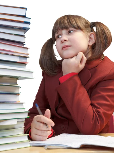 Schoolgirl, schoolwork and stack of books — Stock Photo, Image