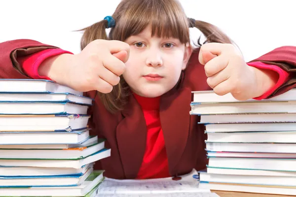 Schoolgirl, schoolwork and stack of books — Stock Photo, Image