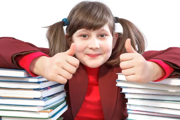 Schoolgirl, schoolwork and stack of books — Stock Photo, Image