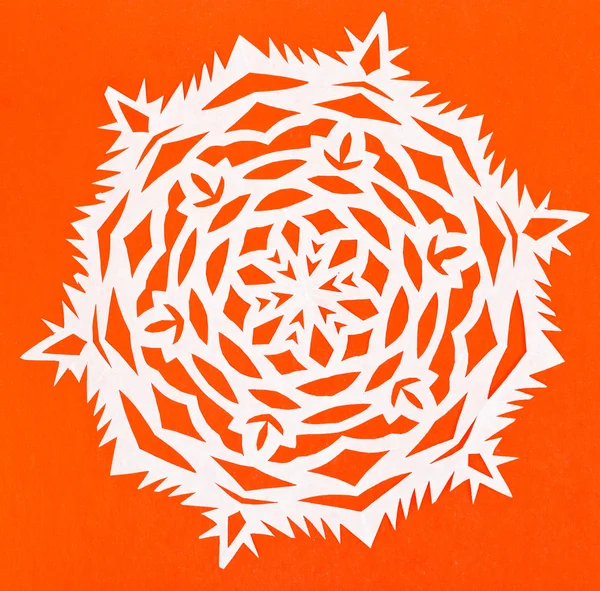 White snowflake on orange paper — Stock Photo, Image