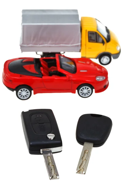 Two vehicle keys and model truck and car — Stock Photo, Image