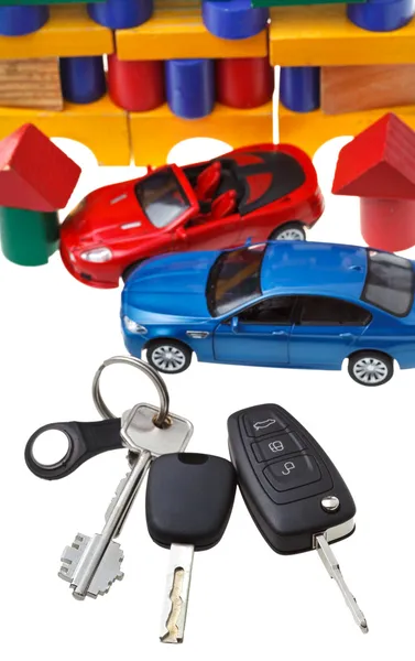 Drzwi, klucze pojazdu, dwa modele samochodów i blok dom — Zdjęcie stockowe