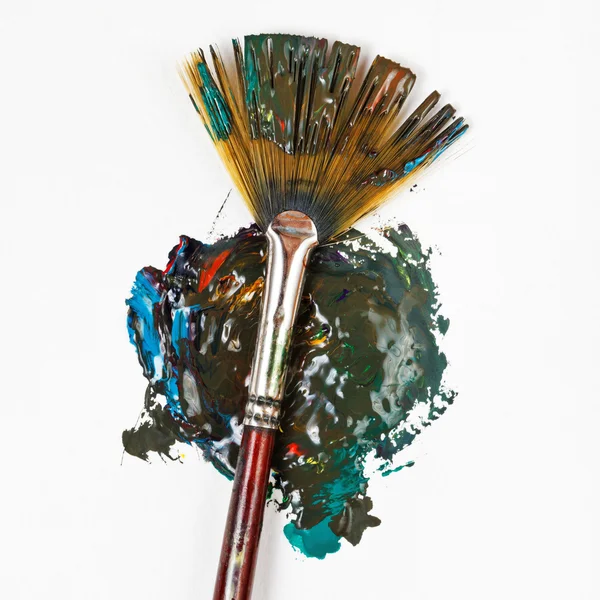 Fan paintbrush blends multicolored watercolors — Stock Photo, Image