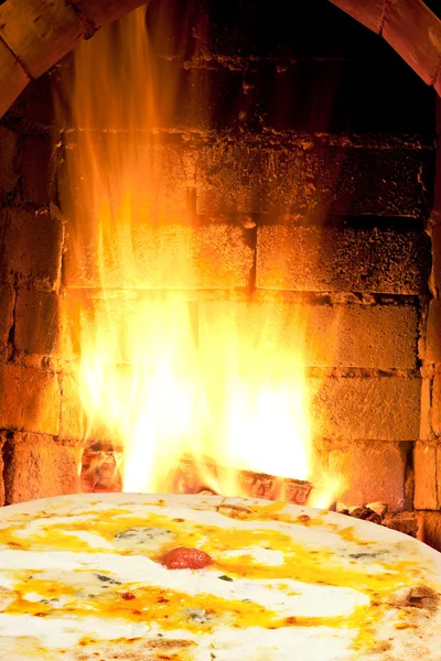 Pizza quatro formaggi and fire flames in oven — Stock Photo, Image