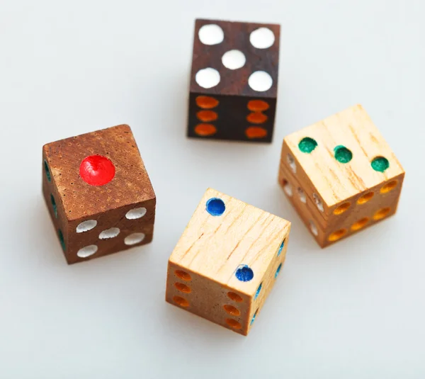 Four wooden gambling dices on white table — Stock Photo, Image