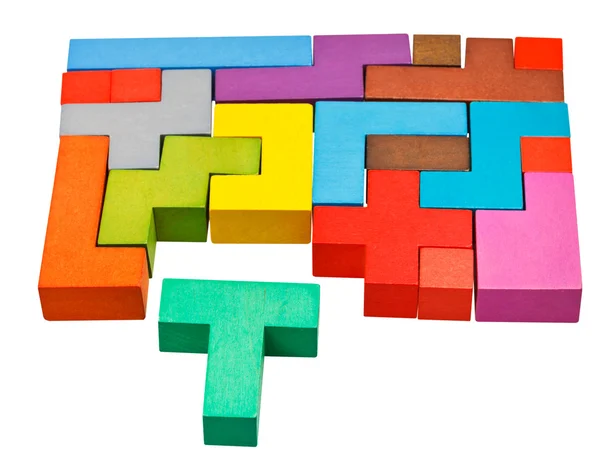 Multicoloured puzzle blocks and T-shaped piece — Stock Photo, Image