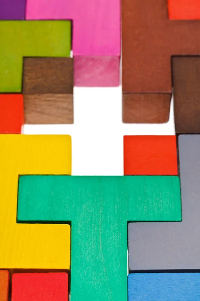 Ahşap renkli puzzle'nın çapraz delik — Stok fotoğraf