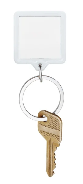 Door brass key and square keychain on ring — Stock Photo, Image