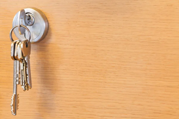 Bunch of keys in lock of wooden door — Stock Photo, Image