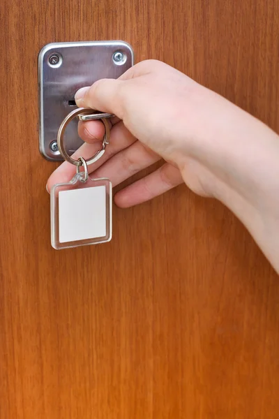 Opening home door by key with blank keychain — Stock Photo, Image