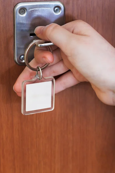 Opening house door by key with blank keychain — Stock Photo, Image